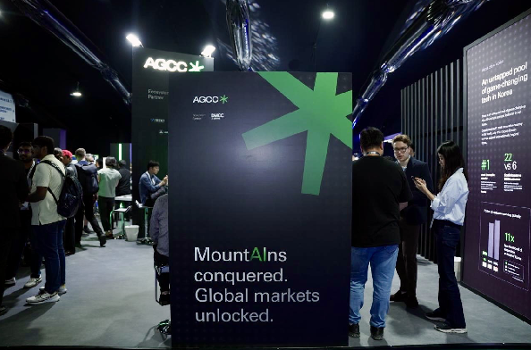 AGCC booth at Expand North Star 2024 with the slogan "MountAIns conquered. Global markets unlocked." displaying AGCC's commitment to unlocking global markets for AI-driven startups.