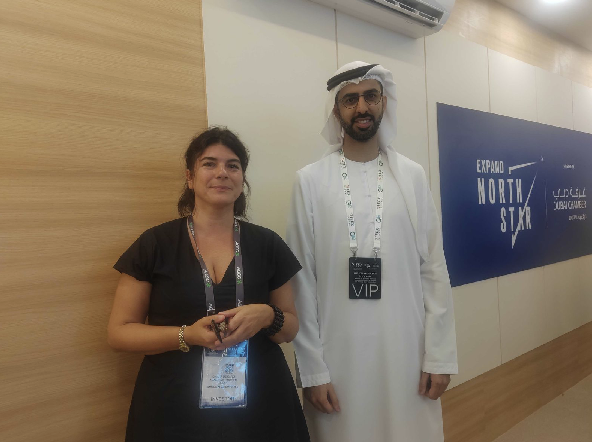 Chiara de Caro, Managing Partner at AGCC, standing with H.E. Omar Sultan AlOlama, UAE's Minister of AI, at Expand North Star 2024.