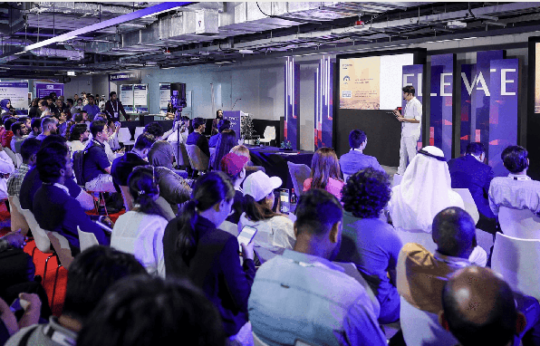 Engaged audience attending a startup pitch session at the DMCC x AGCC Global AI Competition Sustainability Edition on the Elevate Stage during Expand North Star 2024.