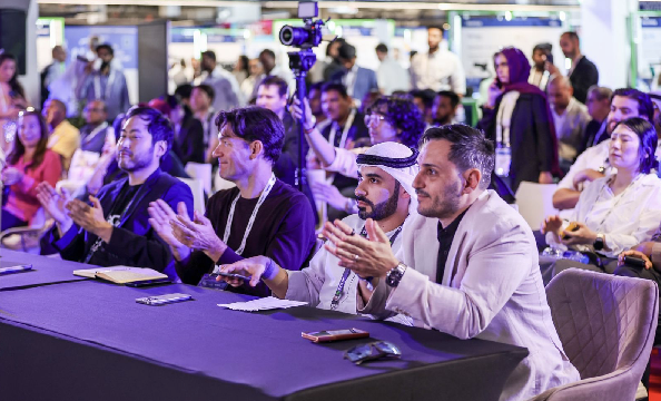 Judge panel applauding a startup's presentation at the DMCC x AGCC Global AI Competition Sustainability Edition during Expand North Star 2024, showcasing positive engagement and encouragement.